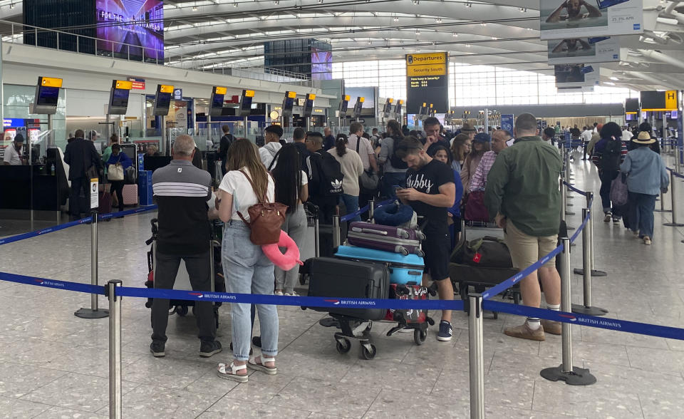 Passengers queue to check-in at terminal 2 at Heathrow Airport, London, as families embark on getaways at the start of the summer holidays for many schools in England and Wales. Picture date: Monday July 25, 2022.