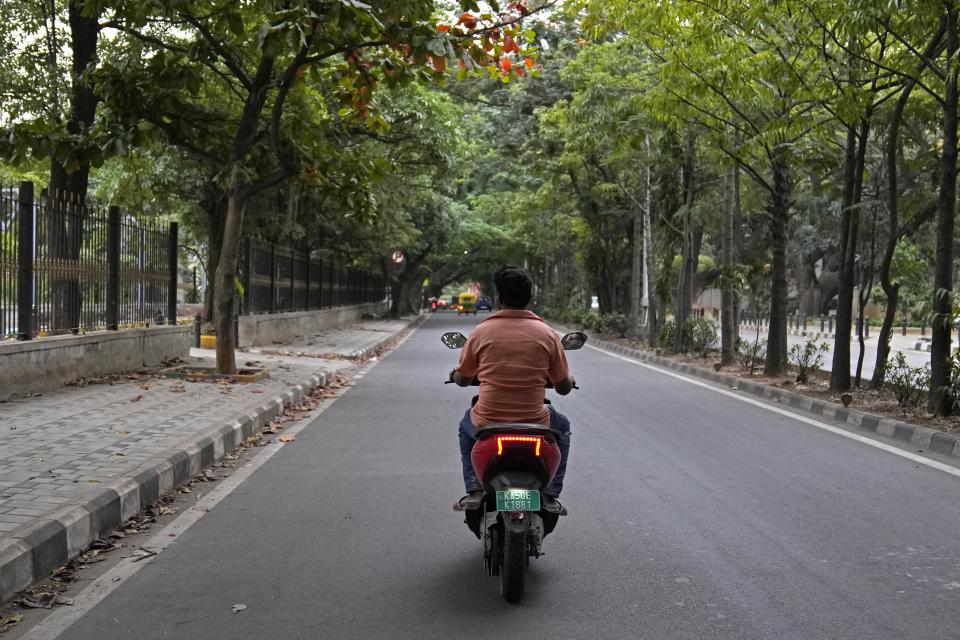 A man rides an electric scooter through a street in Bengaluru, India, Monday, Aug. 28, 2023. India is one of the fastest growing electric vehicle markets in the world. (AP Photo/Aijaz Rahi)