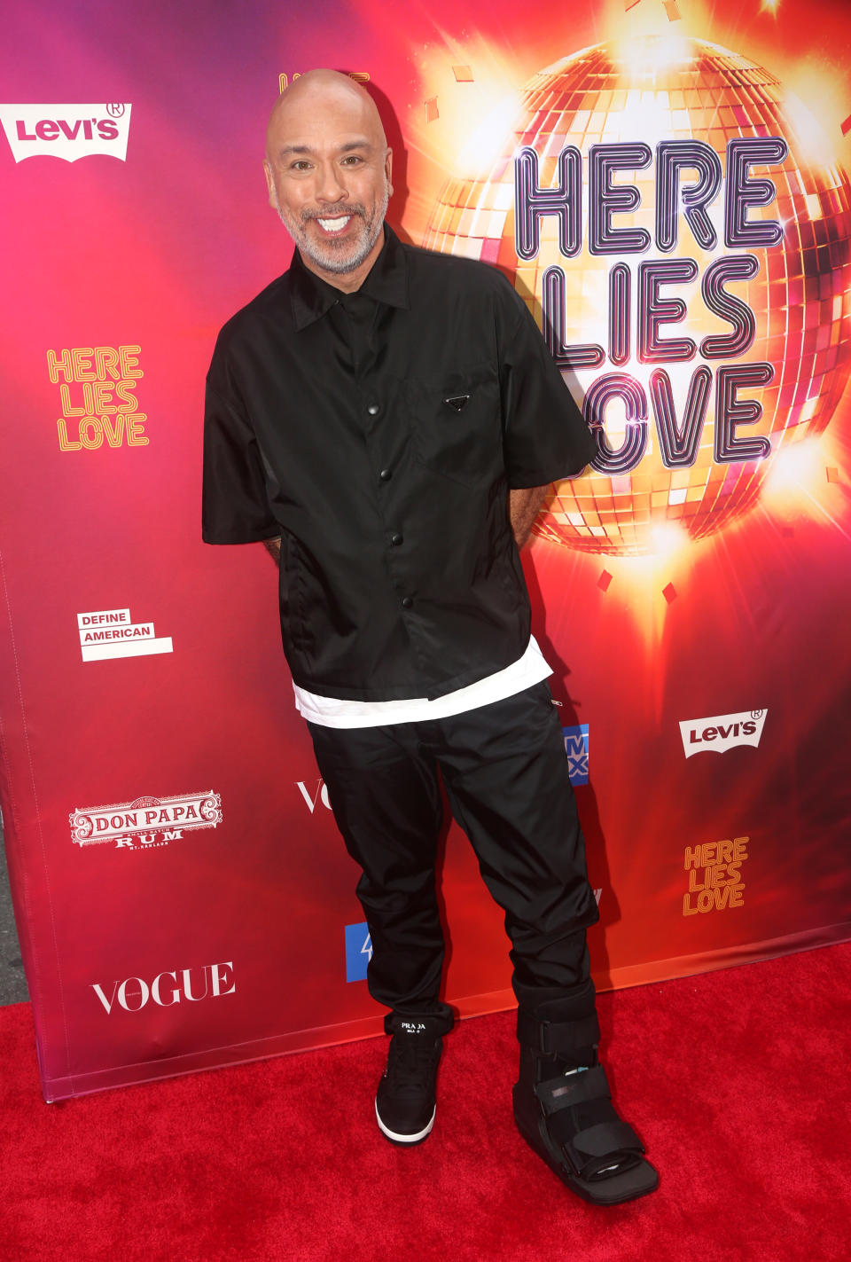 Jo Koy smiles at camera in a black outfit