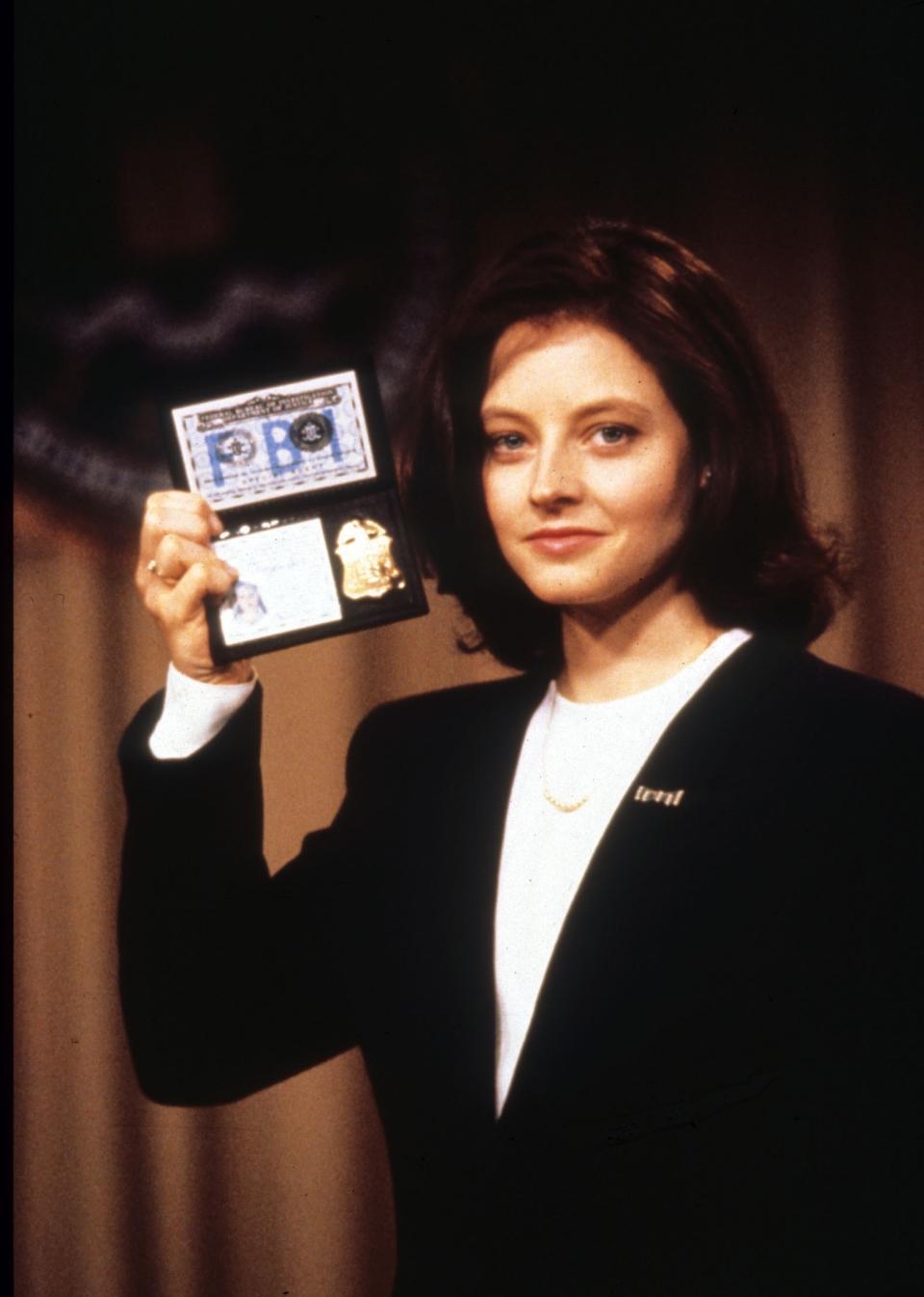 Clarice holding up her FBI badge