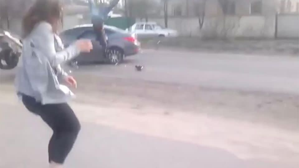 The motorcyclist was seen flying over the top of the car. Source: YouTube