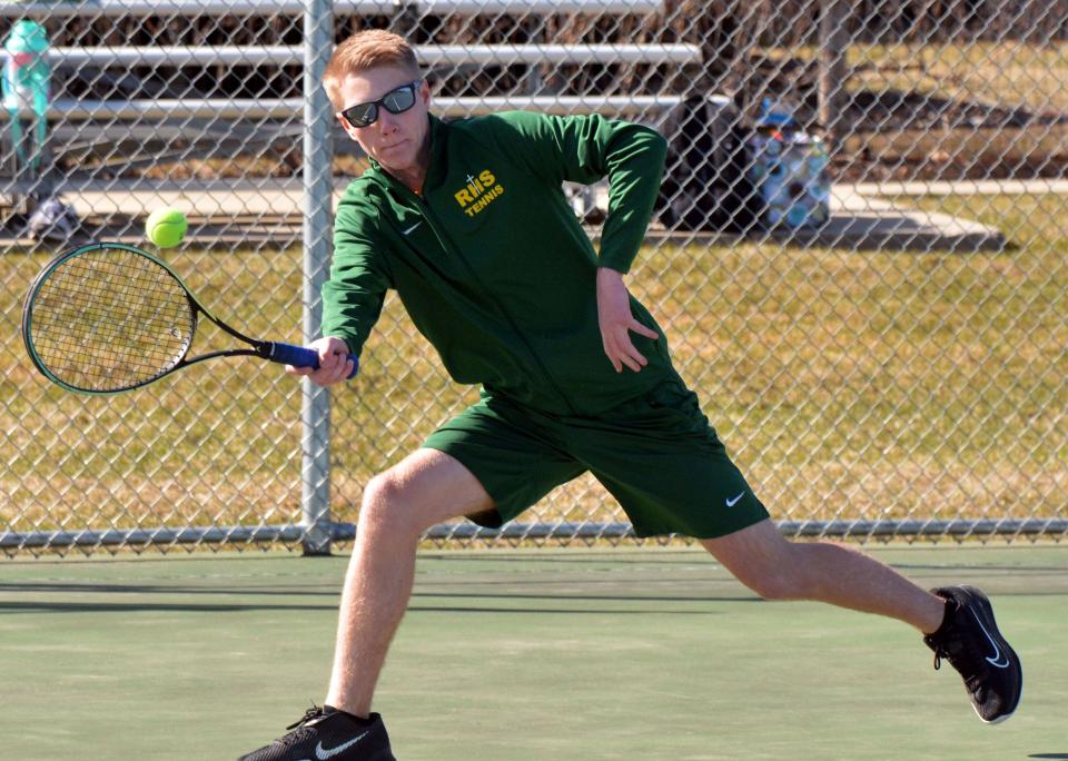 Aberdeen Roncalli's Palmer Johnson hits a forehand return during a high school boys tennis triangular on Monday, April 17, 2023 at the Highland Park Tennis Courts in Watertown.