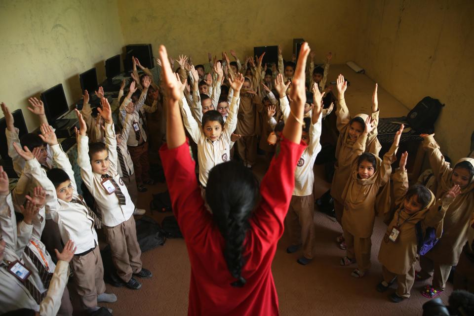 Afghan students perform yoga during the first International Yoga Day, at a private school in Kabul, Afghanistan, Sunday, June 21, 2015. Thousands of yoga enthusiasts took part in mass yoga programs to mark the first International Yoga Day throughout the world. (AP Photo/Massoud Hossaini)