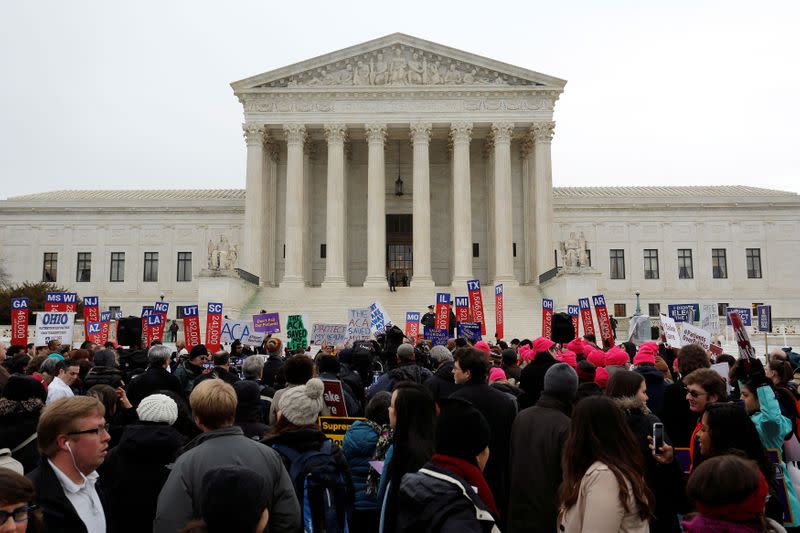 FILE PHOTO: Demonstrators in favor of Obamacare gather at the Supreme Court building in Washington