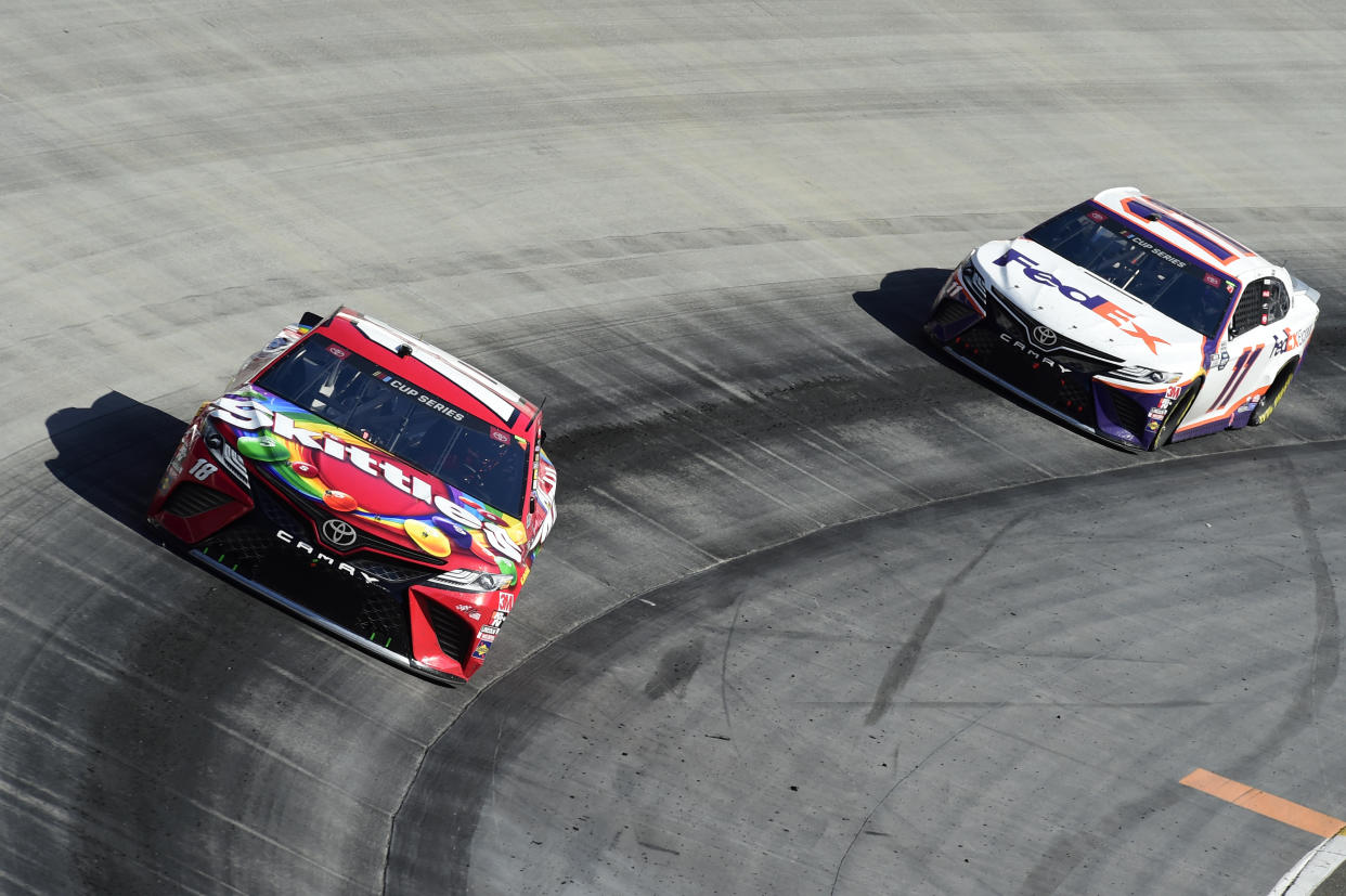 BRISTOL, TENNESSEE - MAY 31: NASCAR Kyle Busch, driver of the #18 Skittles Toyota, leads Denny Hamlin, driver of the #11 FedEx Express Toyota, during the NASCAR Cup Series Food City presents the Supermarket Heroes 500 at Bristol Motor Speedway on May 31, 2020 in Bristol, Tennessee. (Photo by Jared C. Tilton/Getty Images)