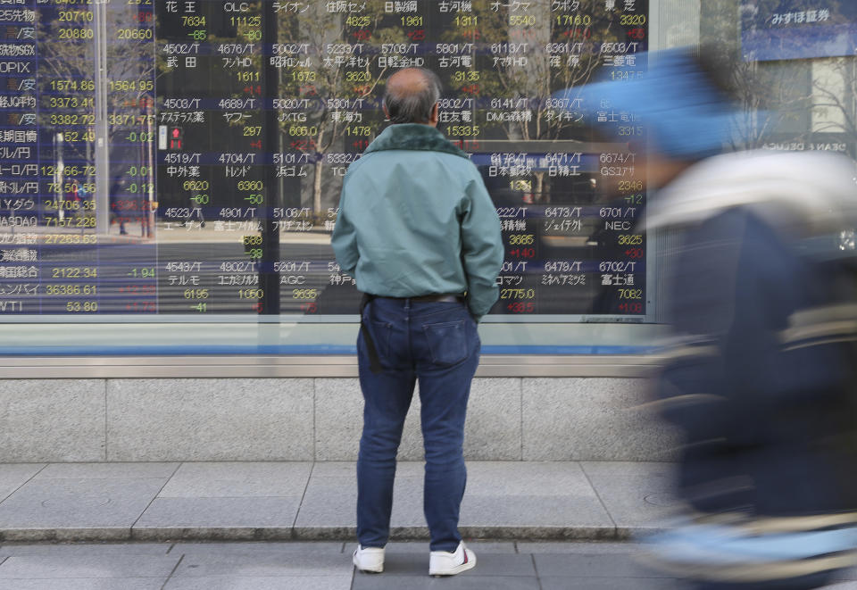 A man looks at an electronic stock board of a securities firm in Tokyo, Monday, Jan. 21, 2019. Shares in Asia rose Monday, extending gains on Wall Street last week. Buying enthusiasm has been spurred by renewed hopes for progress on resolving the trade standoff between the U.S. and China. Shares rose in Shanghai and Hong Kong early Monday despite news that China’s economy grew at its lowest pace in three decades last year. (AP Photo/Koji Sasahara)