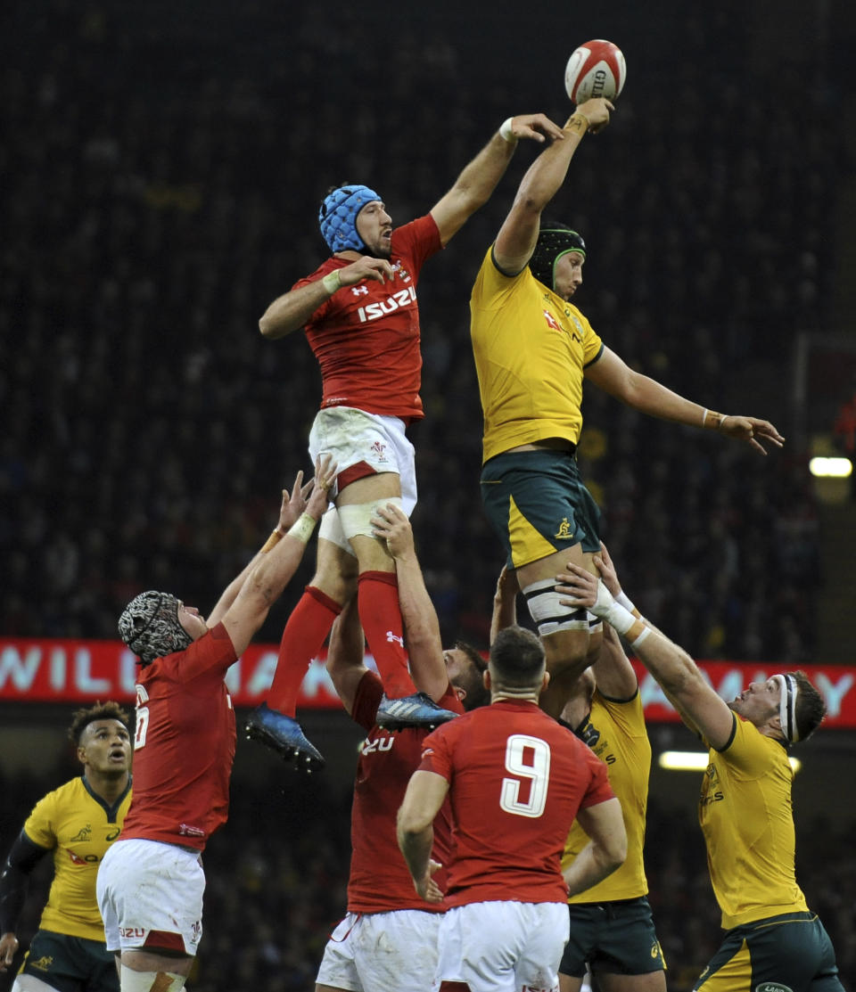 Australia's Adam Coleman, right, taps the ball ahead of Wales Justin Tipuric during the rugby union international match between Wales and Australia at the Principality Stadium in Cardiff, Wales, Saturday, Nov. 10, 2018. (AP Photo/Rui Vieira)