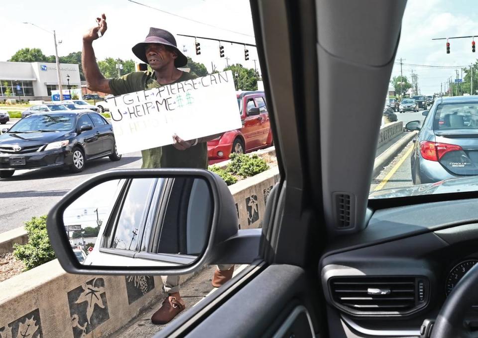 Kenny Miller a panhandler works the intersection of South Boulevard and Woodlawn Road in Charlotte, hoping to receive money from passing motorists.
