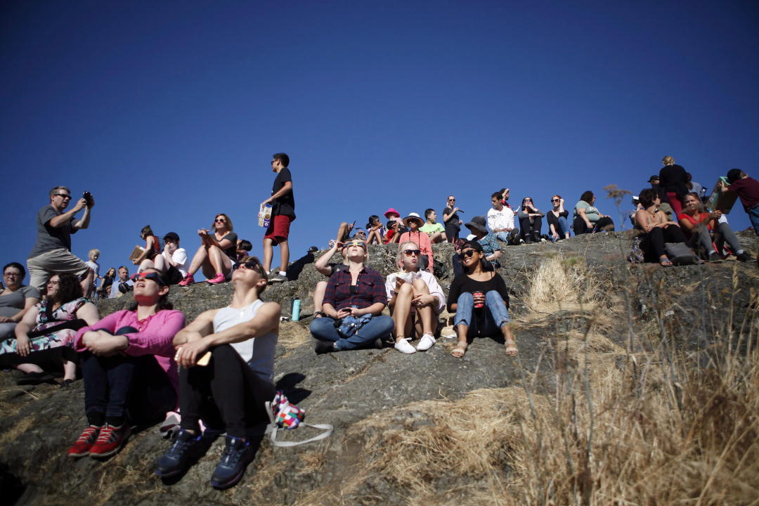 Hundreds of people gathered at Mount Tolmie to take in the partial solar eclipse in Victoria, B.C., on Monday, August 21, 2017. THE CANADIAN PRESS/Chad Hipolito