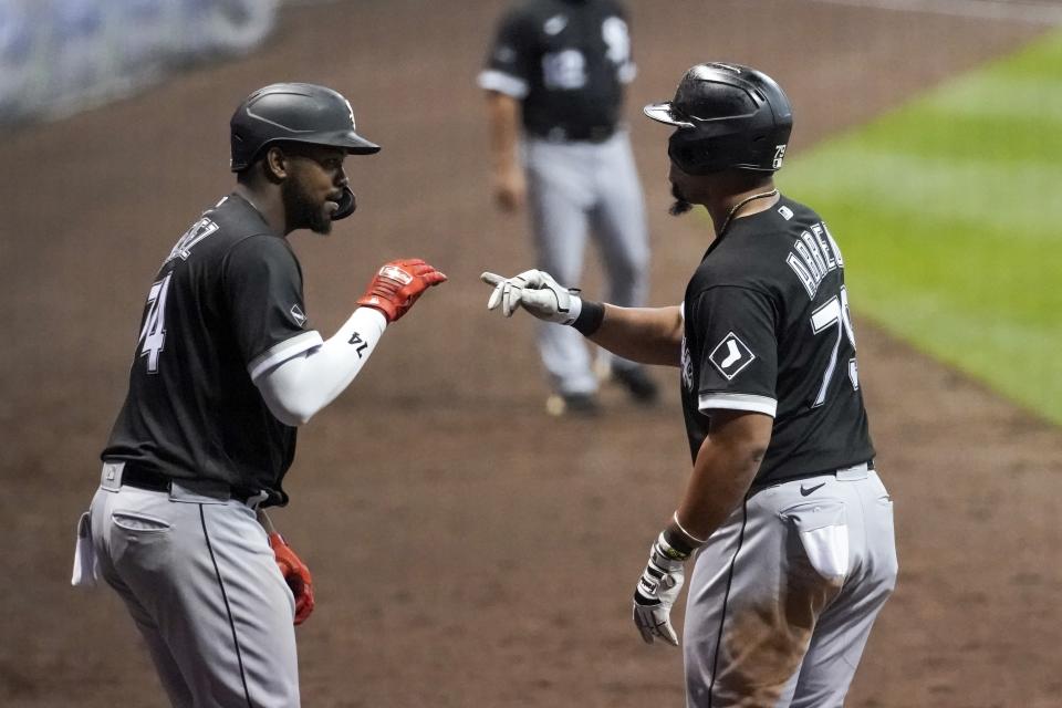 Chicago White Sox's Jose Abreu celebrates with Eloy Jimenez (74) after hitting a two-run home run during the seventh inning of a baseball game against the Milwaukee Brewers Monday, Aug. 3, 2020, in Milwaukee. (AP Photo/Morry Gash)