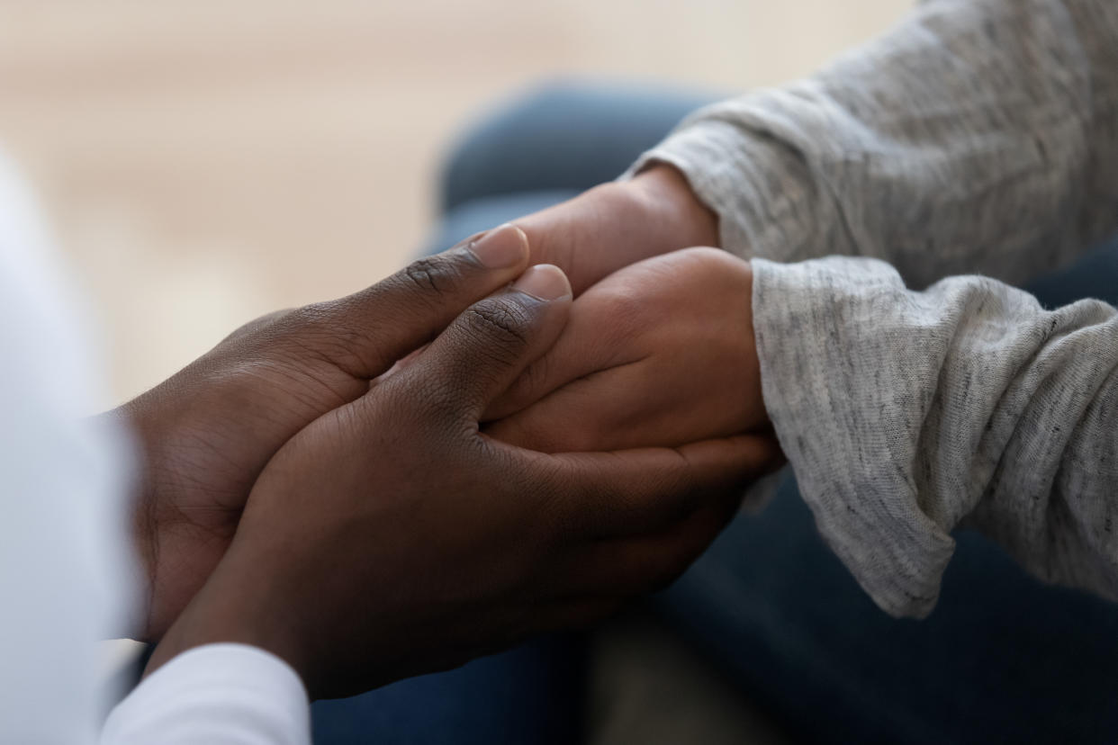 Mixed ethnicity family couple holding hands express support trust hope in marriage relationship, african black man friend husband give comfort compassion empathy to white woman wife, close up view