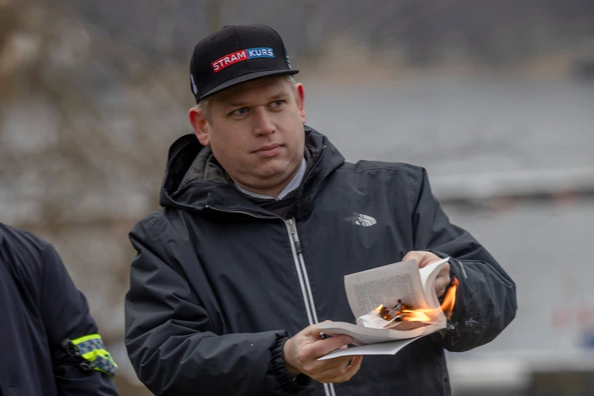 Rasmus Paludan burns a Quran on January 21, 2023, outside the Turkish embassy in Stockholm, Sweden (Getty Images)