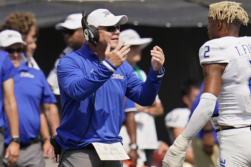 Tulsa head coach Philip Montgomery gestures to his team during a timeout in the second half of an NCAA college football game against Oklahoma State, Saturday, Sept. 11, 2021, in Stillwater, Okla. (AP Photo/Sue Ogrocki)