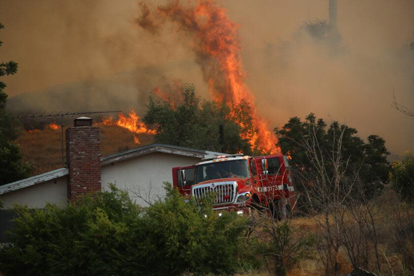 Riverside County, CA - July 15: CalFire crews prepare to defend a Beaumont home from the raging Rabbit Fire amid triple-digit heat in Riverside County Saturday, July 15, 2023. (Allen J. Schaben / Los Angeles Times)