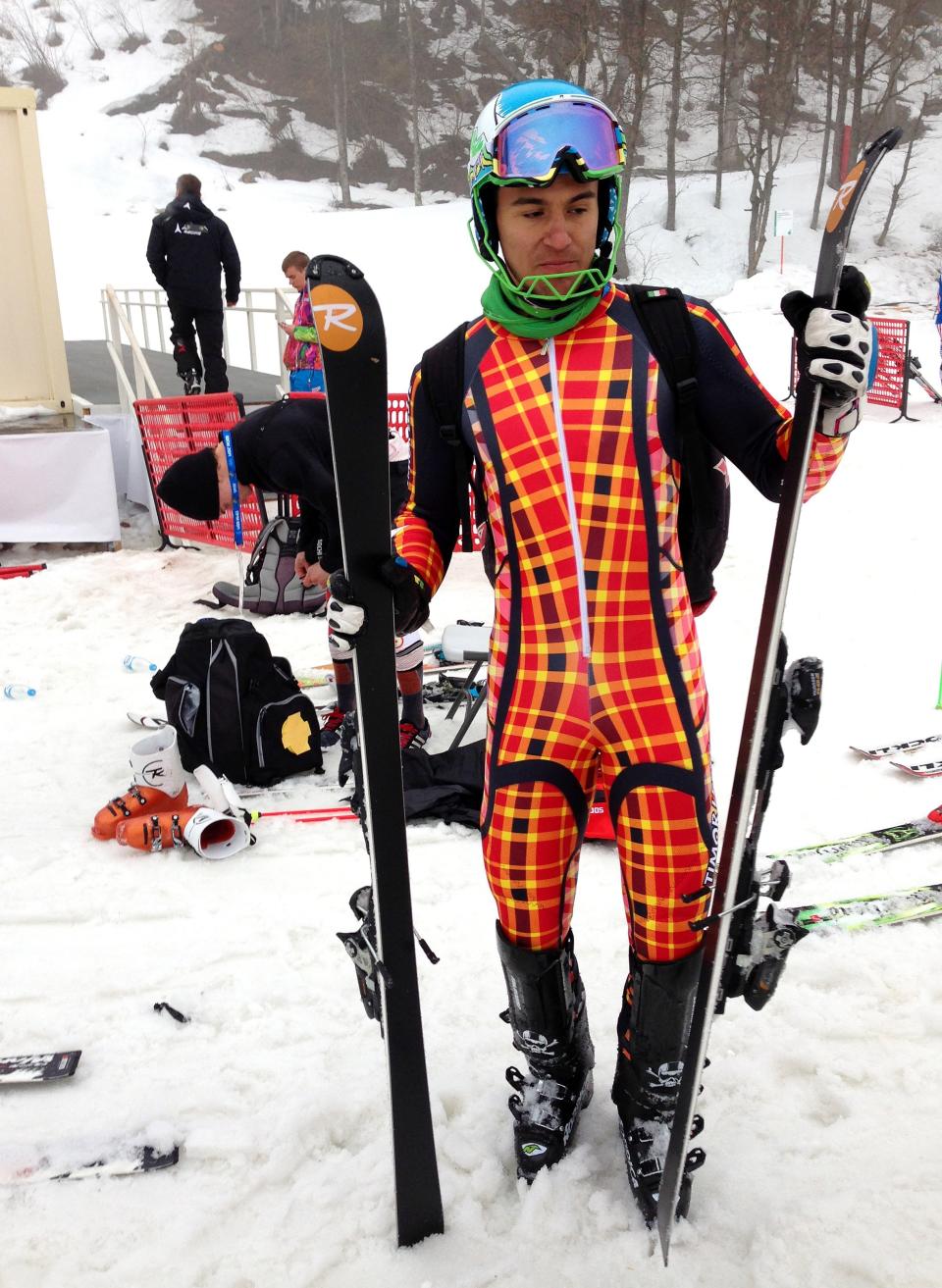 East Timor's Yohan Goncalves Goutt stands with his skis near the chairlift of the alpine skiing area at the Sochi 2014 Winter Olympics, Monday, Feb. 17, 2014, in Krasnaya Polyana, Russia. Goncalves Goutt, 19, is preparing to compete as an Alpine skier in the Sochi Games, representing East Timor, whose officially recognized ski federation he founded. His race, the slalom, is Saturday night. (AP Photo/Andrew Dampf)