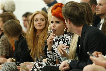 Singer Paloma Faith eats a lollipop before the Matthew Williamson Spring/Summer 2014 collection presentation during London Fashion Week September 15, 2013. REUTERS/Suzanne Plunkett