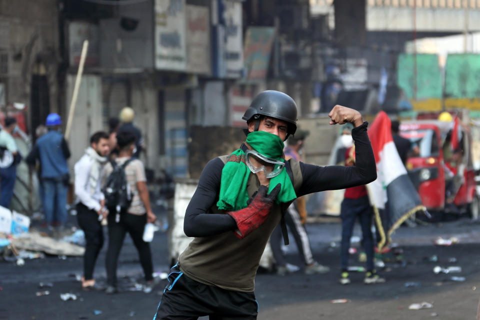 A protester poses during clashes between Iraqi security forces and anti-Government protesters in Baghdad, Iraq, Thursday, Nov. 14, 2019. (AP Photo/Khalid Mohammed)