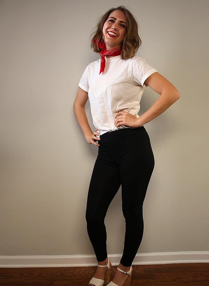 A woman is dressed in a greaser outfit from the movie Grease for a Halloween costume.