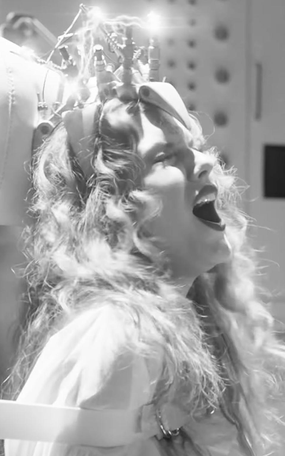 Taylor Swift in the music video for "Fortnight." curly hair