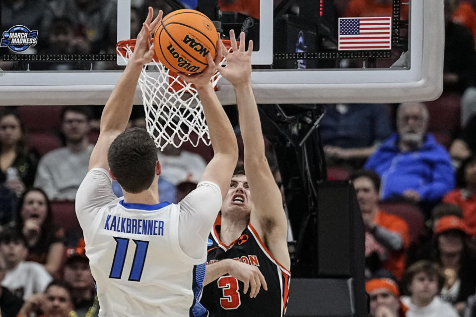 Creighton center Ryan Kalkbrenner (11) shoots against Princeton guard Ryan Langborg (3) in the second half of a Sweet 16 round college basketball game in the South Regional of the NCAA Tournament, Friday, March 24, 2023, in Louisville, Ky. (AP Photo/John Bazemore)