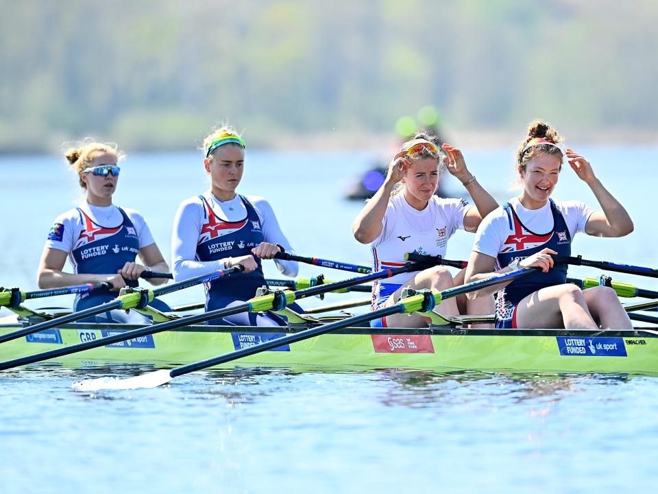 Members of the Great Britain Rowing Team sit in a boat on the water