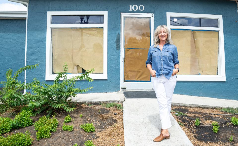 Debbie Cooper stands in front of the new location for Buck + Board, a wine and charcuterie restaurant on 5th street in Columbia, Tenn. on Aug. 30, 2022