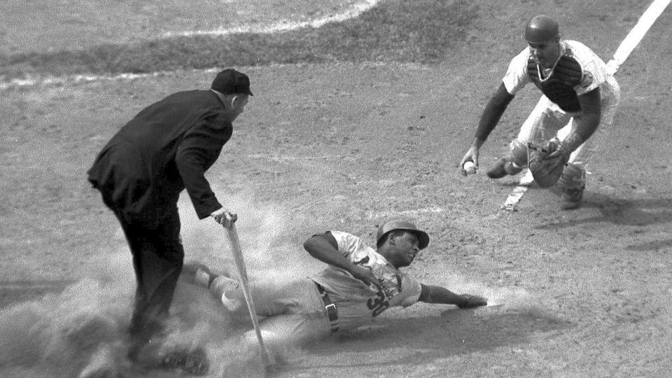 St. Louis Cardinals' Orlando Cepeda scores in the eighth inning of a baseball game as New York Mets catcher J.C. Martin, right, and umpire Tim McCarver, left, watch at Shea Stadium in New York in 1968. - AP/File