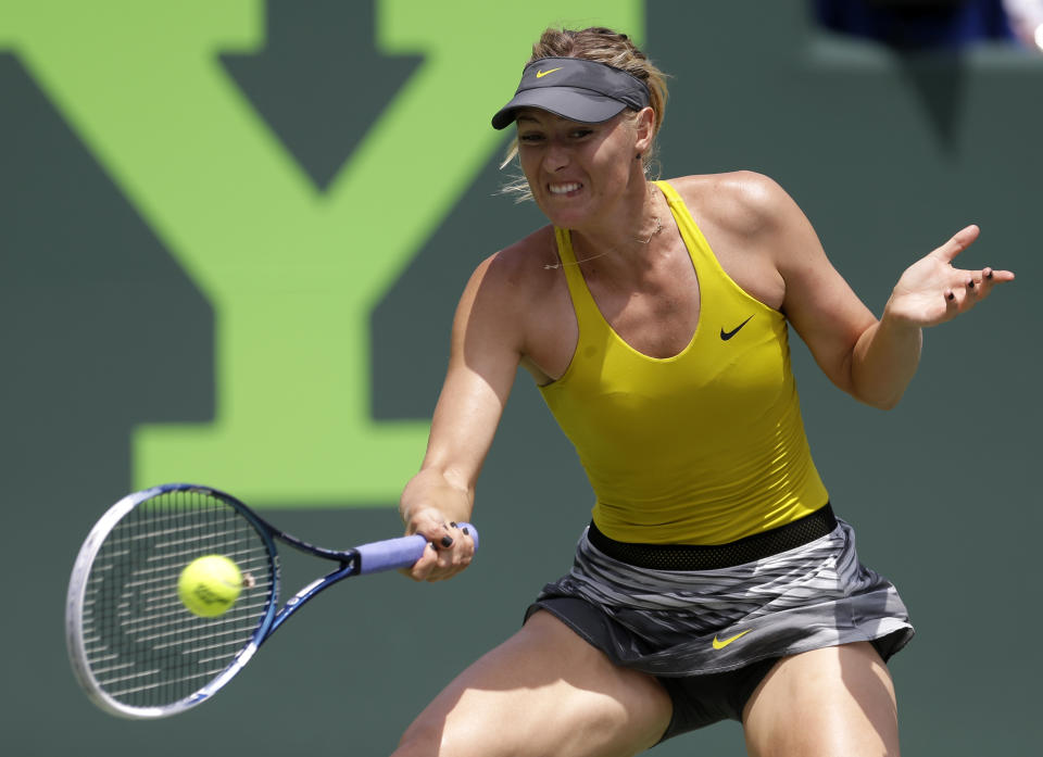 Maria Sharapova, of Russia, returns to Serena Williams at the Sony Open Tennis tournament in Key Biscayne, Fla., Thursday, March 27, 2014. (AP Photo/Alan Diaz)