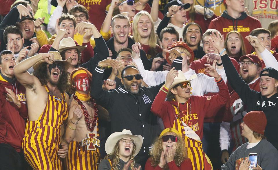 Former Iowa State quarterback Seneca Wallace, middle, and other Cyclone fans enjoy last Saturday's victory over TCU at Jack Trice Stadium.