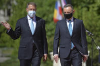 Polish President Andrzej Duda, right, reviews the honor guard with Romanian President Klaus Iohannis during the welcoming ceremony at the Cotroceni presidential palace in Bucharest, Romania, Monday, May 10, 2021. (AP Photo/Alexandru Dobre)