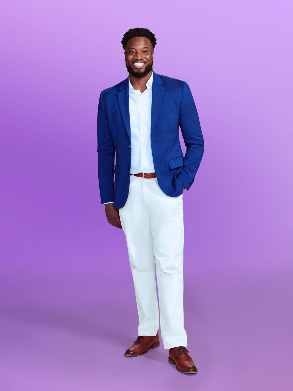 Deion, a candidate at "Love is blind" Season 6, wears a blue jacket and white pants