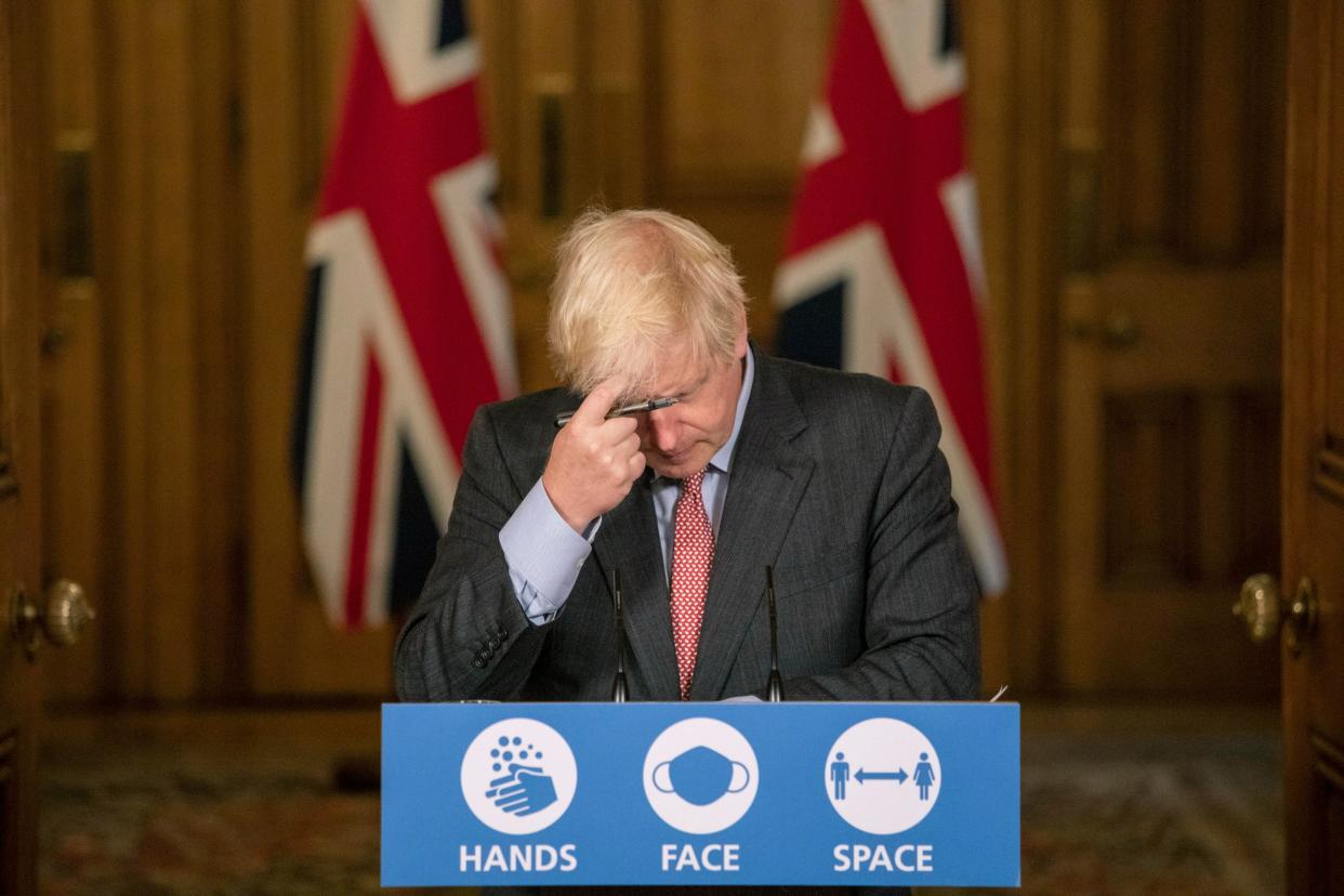 Boris Johnson held a briefing as the UK passed the 100,000 death mark on Tuesday (AP)