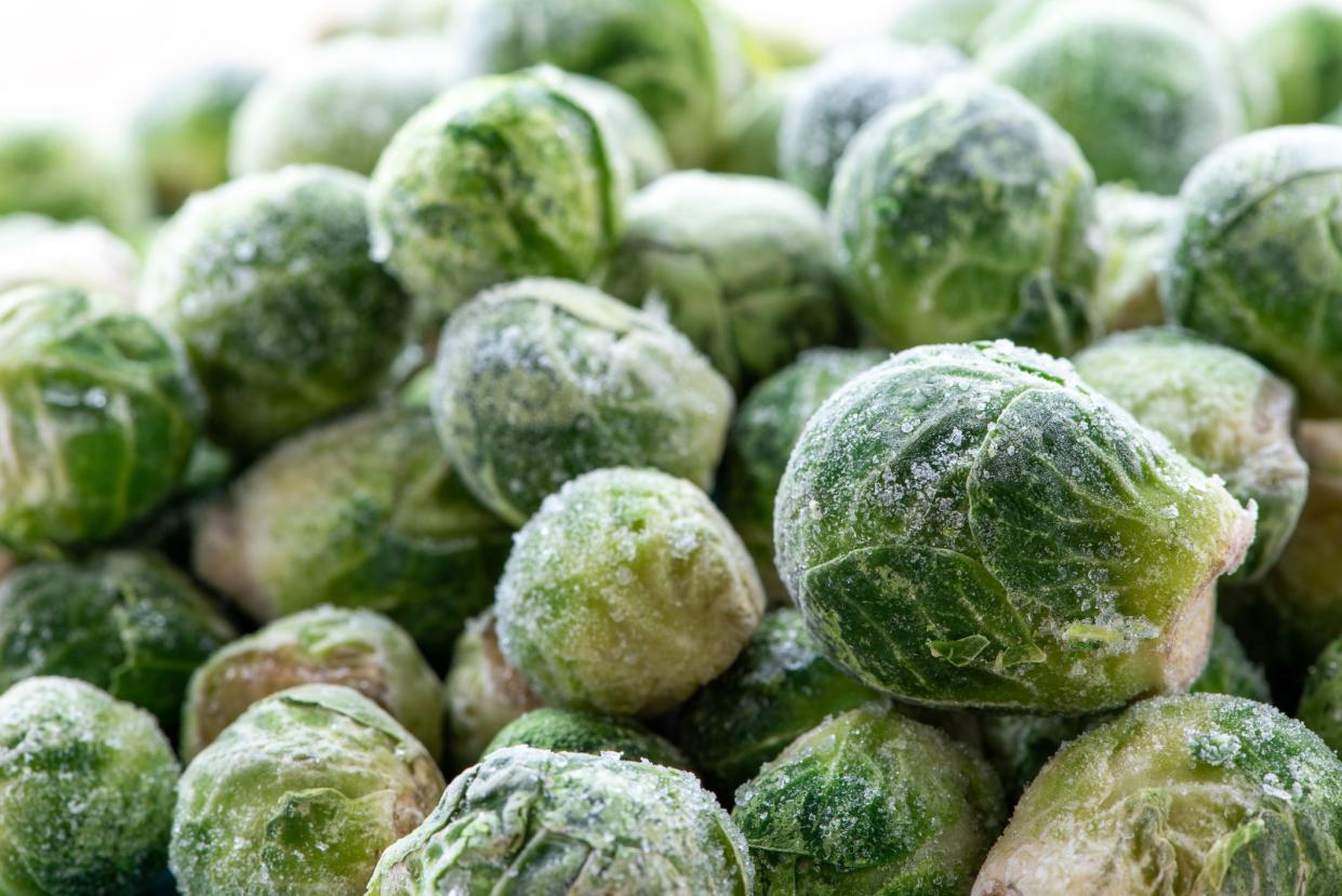 A pile of frozen brussels sprouts close up.