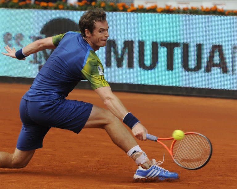 British player Andy Murray returns the ball to German player Florian Mayer during their tennis match at the Madrid Masters at the Magic Box (Caja Magica) sports complex in Madrid on May 7, 2013. Murray won 7-6 (13/11), 7-6(7/3)