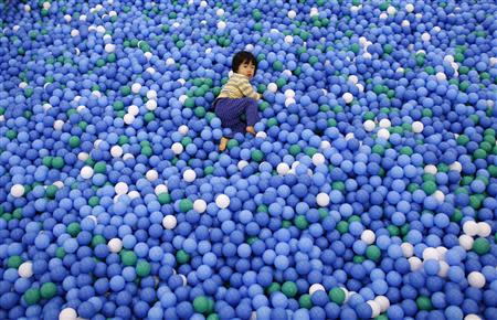 Two-year-old Nao Watanabe plays in a ball pit at an indoor playground which was built for children and parents who refrain from playing outside because of concerns about nuclear radiation in Koriyama, west of the tsunami-crippled Fukushima Daiichi nuclear power plant, Fukushima prefecture February 27, 2014. REUTERS/Toru Hanai