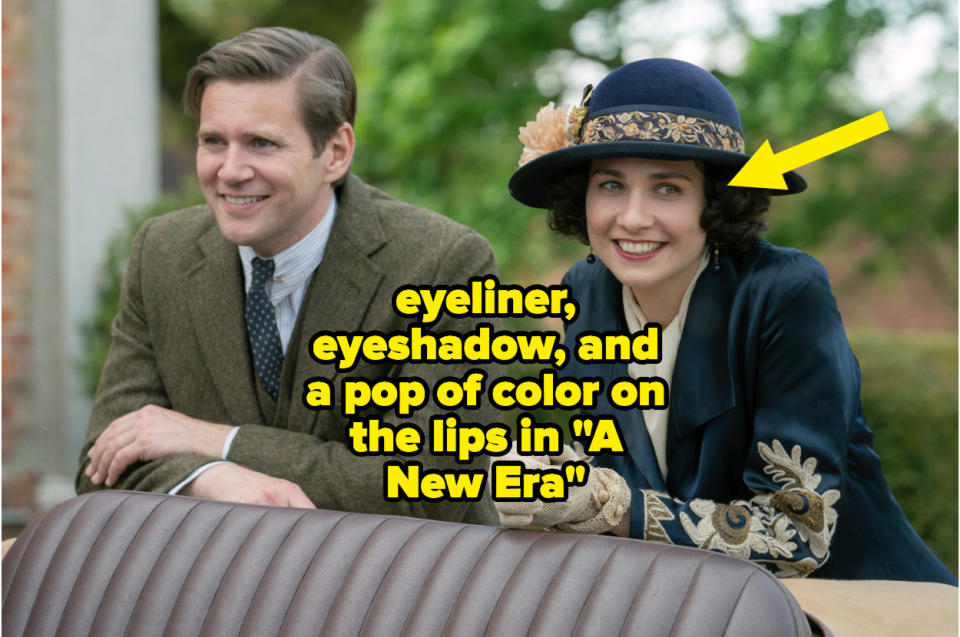 A man and woman smiling in "Downton Abbey: A New Era" with an arrow pointing out the woman is wearing more eyeliner, eyeshadow, and lipstick