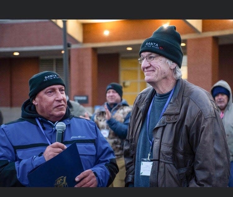 Mike Peters and Larry Pickles appear in 2022 for the 60th year of Santa on the River, an annual floating display on the St. Joseph River in Niles.