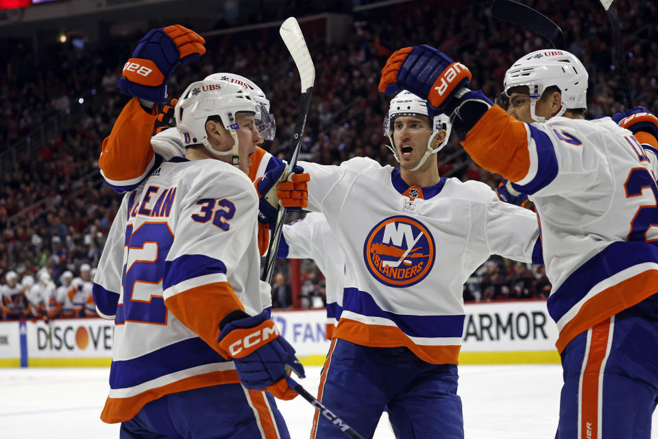 New York Islanders' Kyle MacLean (32) celebrates his goal with teammates during the first period in Game 1 of an NHL hockey Stanley Cup first-round playoff series against the Carolina Hurricanes in Raleigh, N.C., Saturday, April 20, 2024. (AP Photo/Karl B DeBlaker)