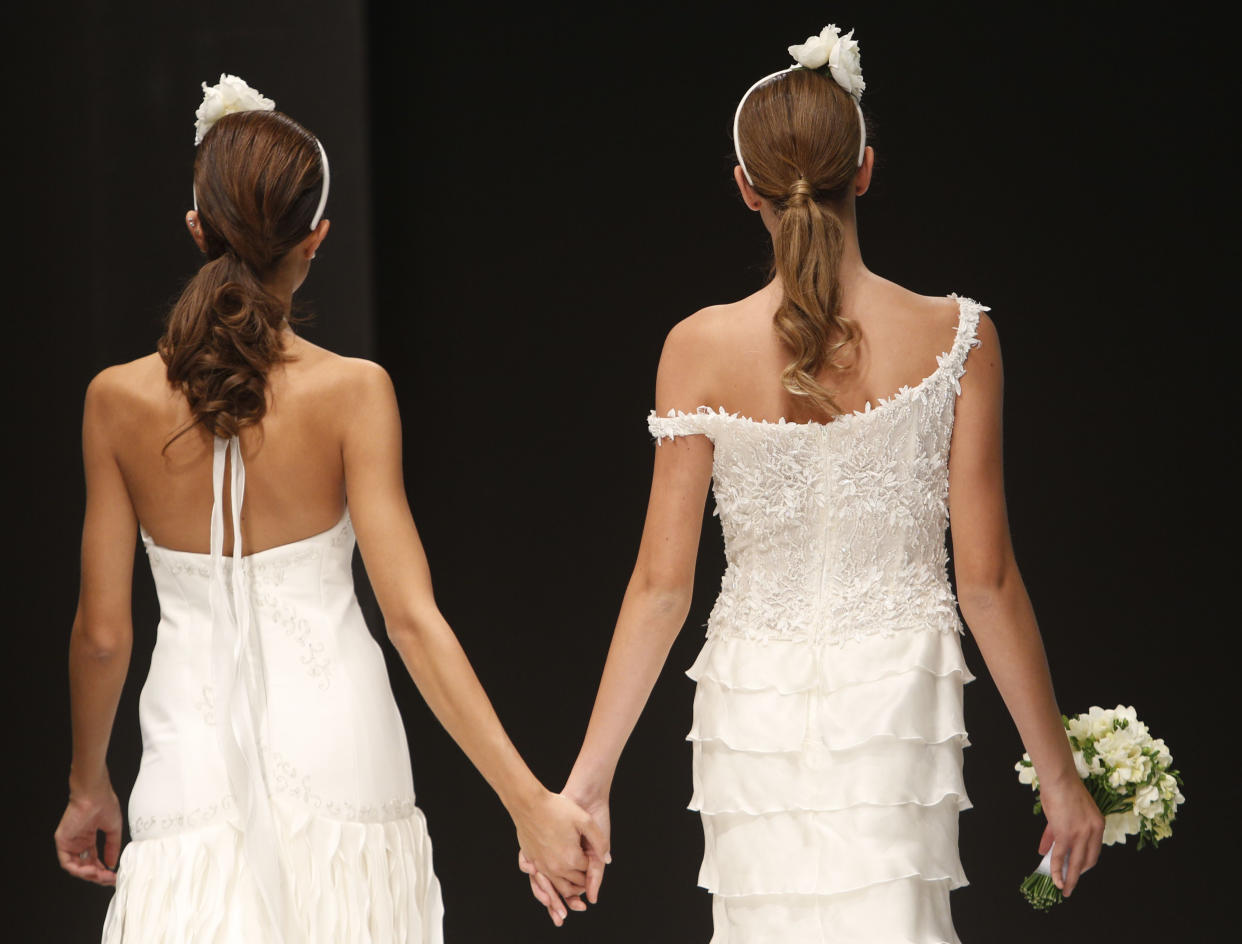 FILE -- Models wear wedding dresses during "The rainbow wedding fashion show", with same-sex couples in Rome, in this Thursday, Oct. 23, 2014 file photo. In an interview with The Associated Press at The Vatican, Tuesday, Jan. 24, 2023, Pope Francis acknowledged that Catholic bishops in some parts of the world support laws that criminalize homosexuality or discriminate against the LGBTQ community, and he himself referred to homosexuality in terms of "sin." But he attributed attitudes to cultural backgrounds and said bishops in particular need to undergo a process of change to recognize the dignity of everyone. (AP Photo/Domenico Stinellis, file)