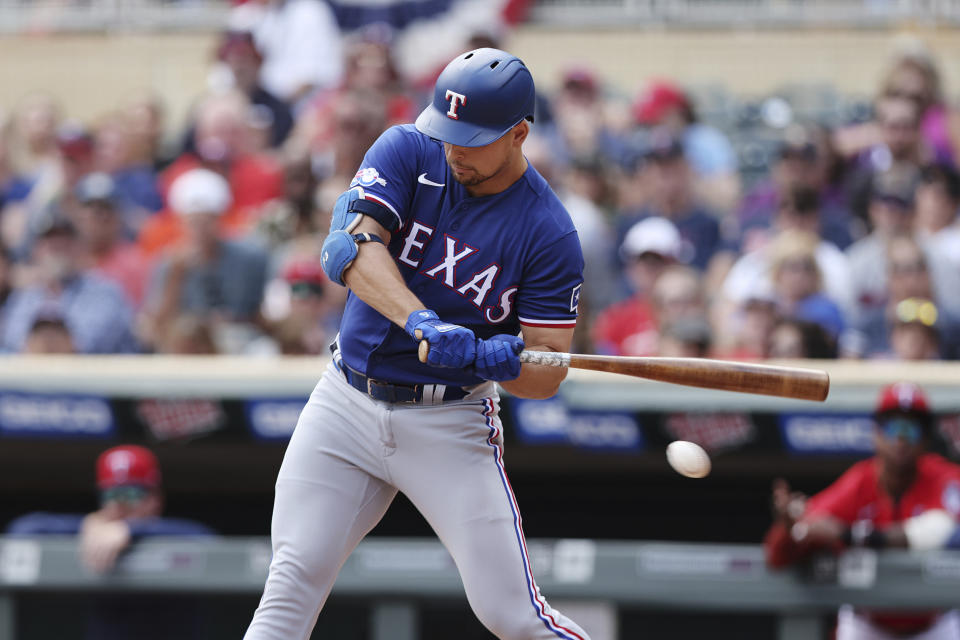 Texas Rangers' Nathaniel Lowe strikes out during the first inning of a baseball game against the Minnesota Twins, Sunday, Aug. 21, 2022, in Minneapolis. (AP Photo/Stacy Bengs)