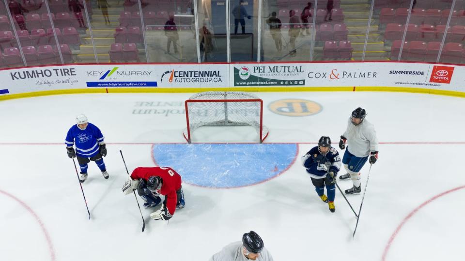 A drone shot shows Smitty (in red) making a save.  