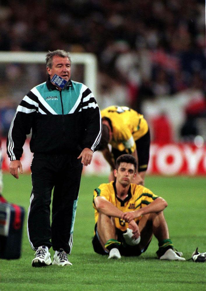 Terry Venables walking Ned Zelic sitting on the pitch after the game 