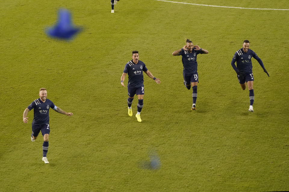 Sporting Kansas City players celebrate after winning an MLS soccer match against the San Jose Earthquakes with a penalty kick in overtime Sunday, Nov. 22, 2020, in Kansas City, Kan. (AP Photo/Charlie Riedel)