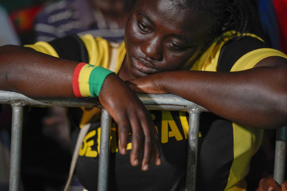 Senegal fans watch their team's World Cup round of 16 soccer match against England, played in Qatar, on a video screen set up at a fan zone in Dakar, Senegal, Sunday Dec. 4, 2022. Senegal lost 0-3. (AP Photo/Leo Correa)