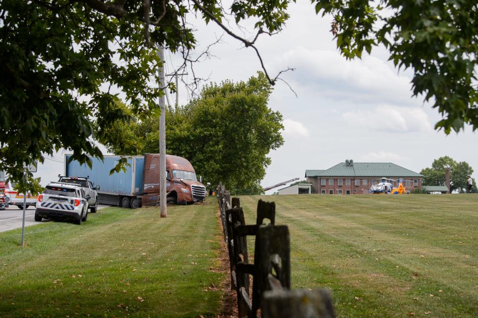 A medical helicopter sits in a golf course next to a wrecked tractor-trailer at the scene where a man was heavily entrapped inside a minivan after a crash on Route 30, Friday, Aug. 2, 2024, in Berwick Township.