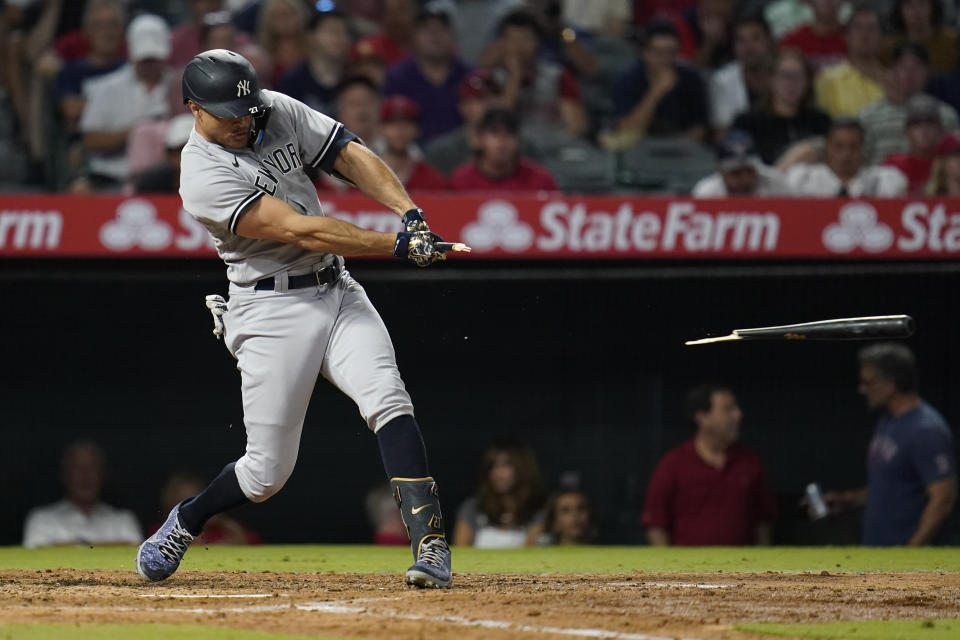 New York Yankees designated hitter Giancarlo Stanton (27) breaks a bat as he grounds in to a forced out during the sixth inning of a baseball game against the Los Angeles Angels in Anaheim, Calif., Wednesday, Aug. 31, 2022. (AP Photo/Ashley Landis)