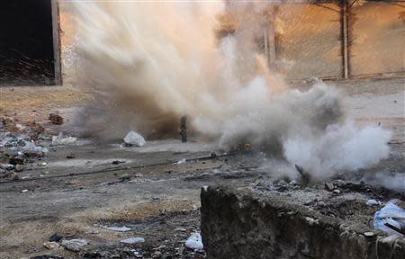 A mortar fired by Free Syrian Army fighters explodes, injuring fighters nearby, in Aleppo