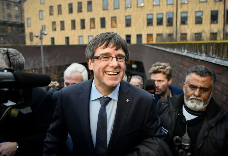 Ousted Catalan leader Carles Puigdemont said he "will not surrender" to Madrid's threats