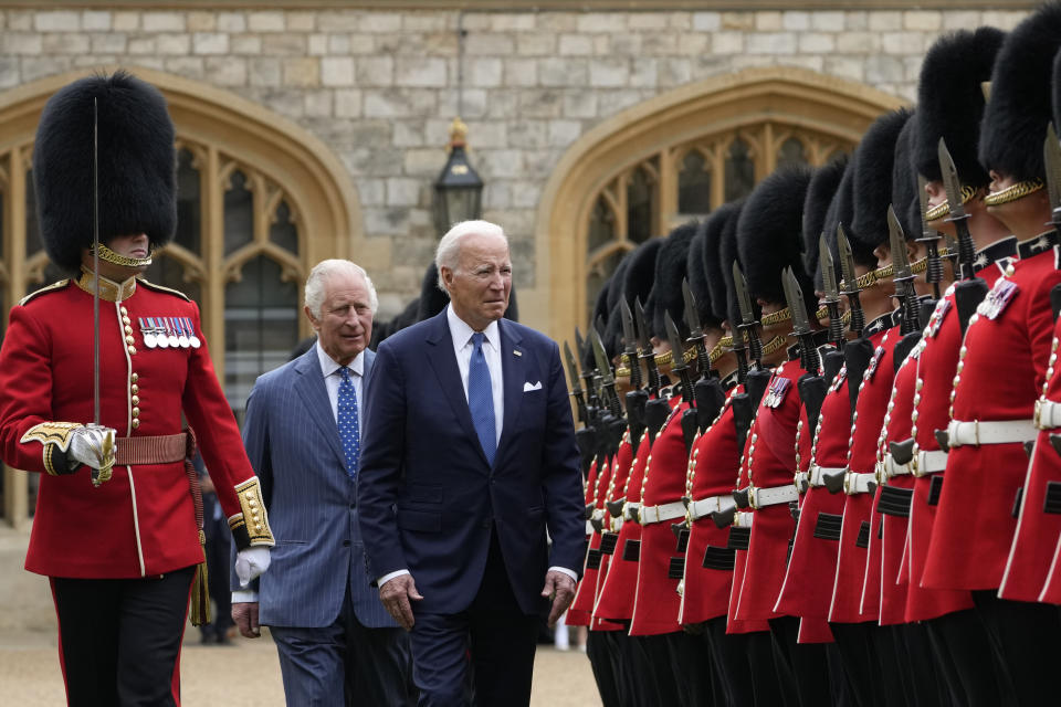 US President Joe Biden reviews royal guards along with Britain's King Charles III during a welcoming ceremony at Windsor Castle in Windsor, England, Monday, July 10, 2023. (AP Photo/Susan Walsh)