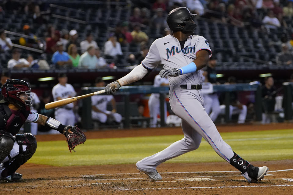 Miami Marlins' Jesus Sanchez follows through on his three run home run against the Arizona Diamondbacks during the fourth inning of a baseball game, Wednesday, May 10, 2023, in Phoenix. (AP Photo/Matt York)